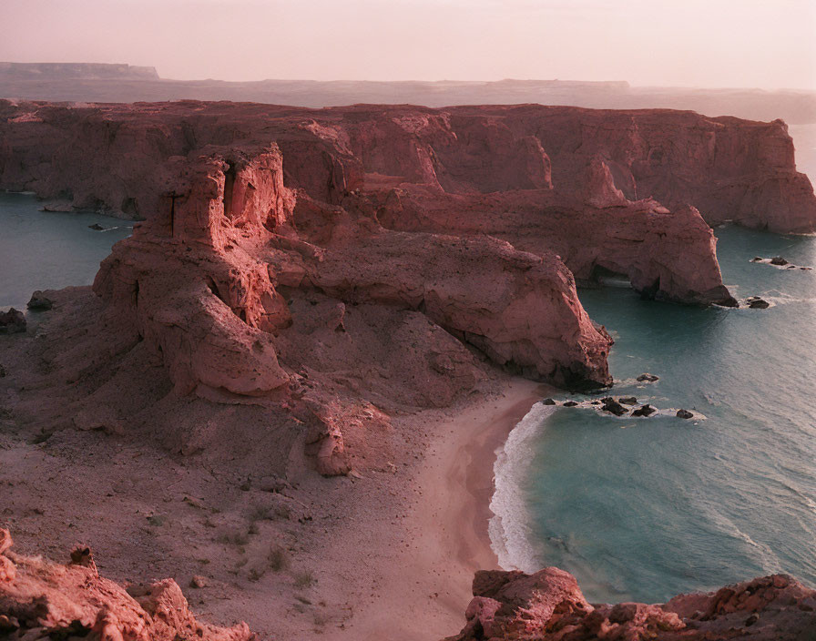 Twilight coastal landscape with rugged cliffs and gentle shoreline