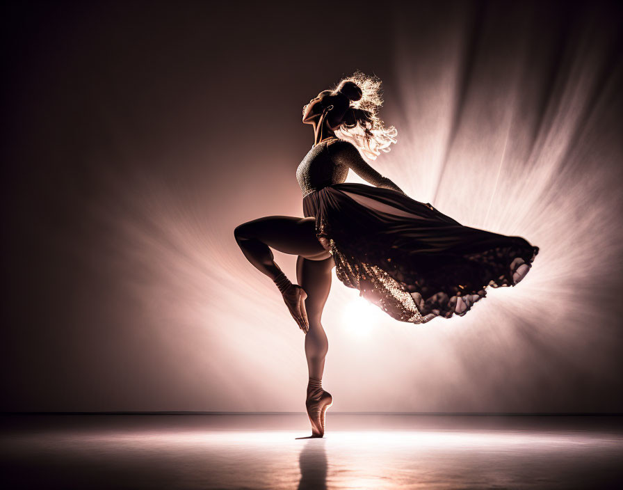 Elegant ballerina silhouette in dramatic pose on stage