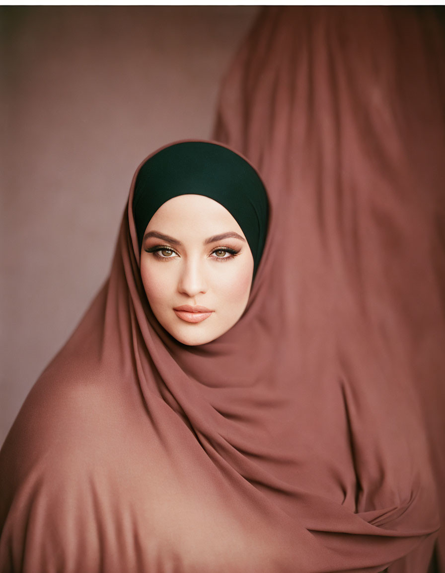 Portrait of Person Wearing Hijab with Elegant Drapery Against Neutral Background