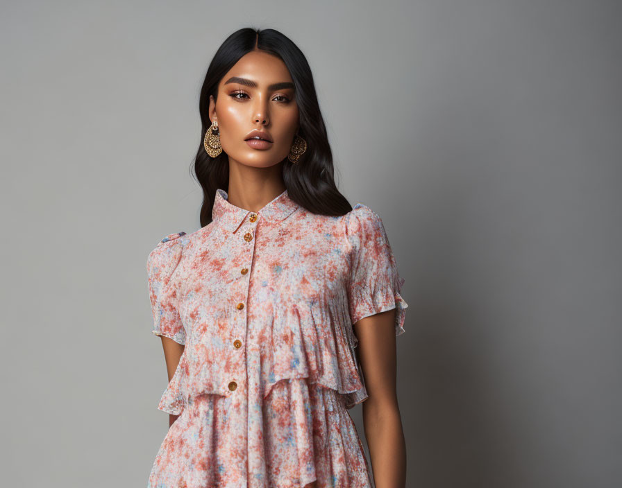 Woman in Floral Ruffled Dress with Earrings on Gray Background