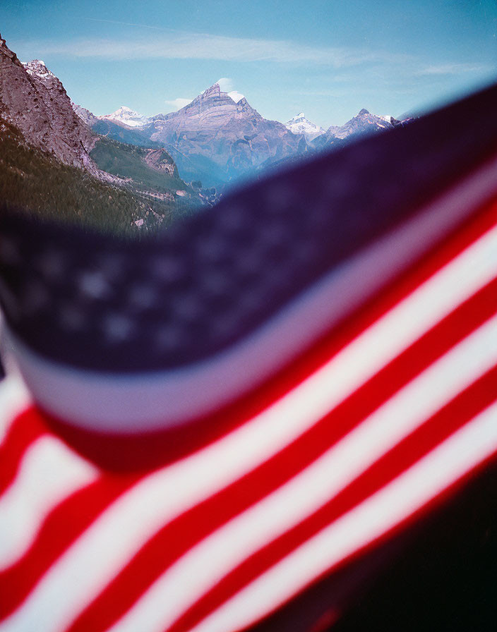 Patriotic American flag with blurry mountain backdrop