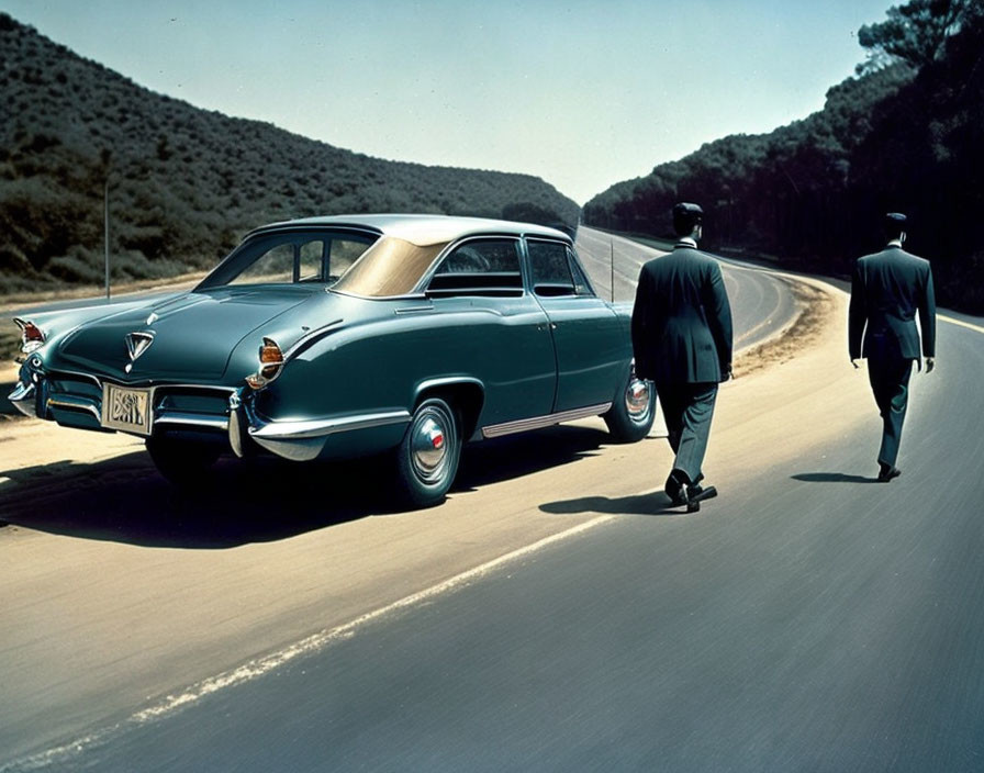 Men in suits and hats by teal classic car on tree-lined road