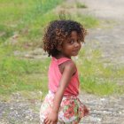 Young girl with large afro in digital artwork against pastel background