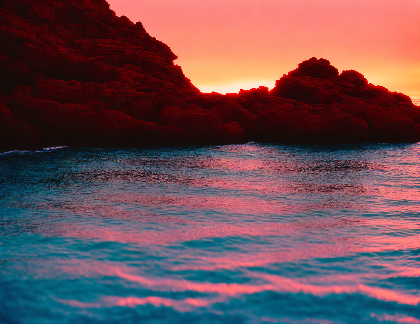 Crimson Skies Sunset Seascape with Silhouetted Rocky Cliffs