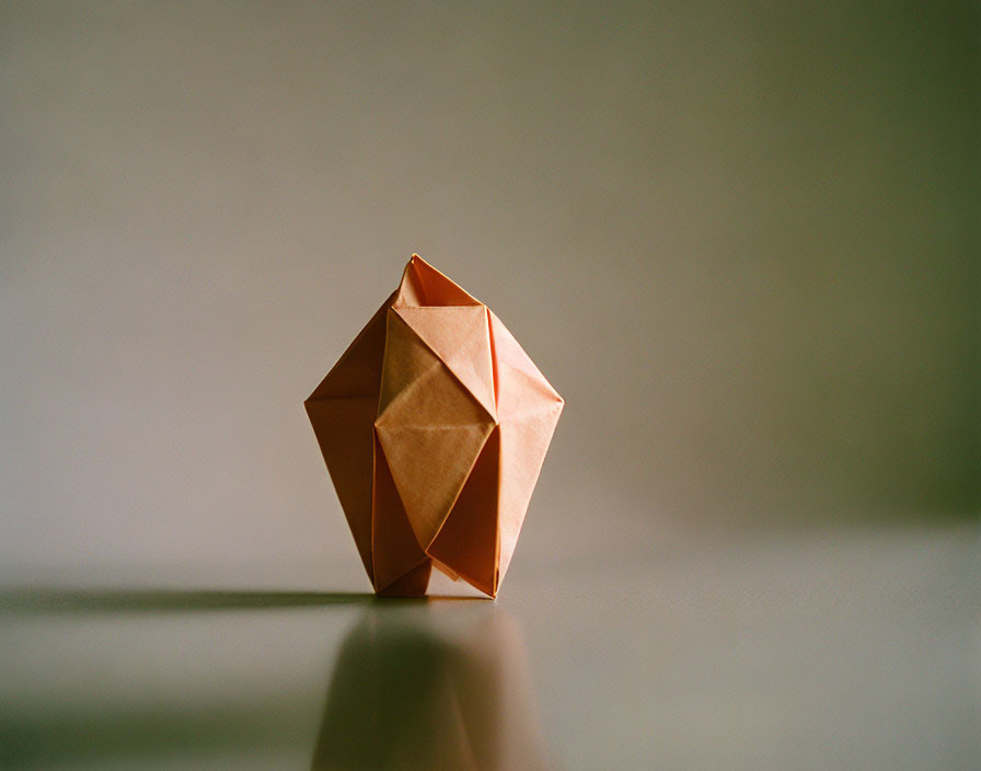 Paper polygon with shadow on light surface and soft lighting