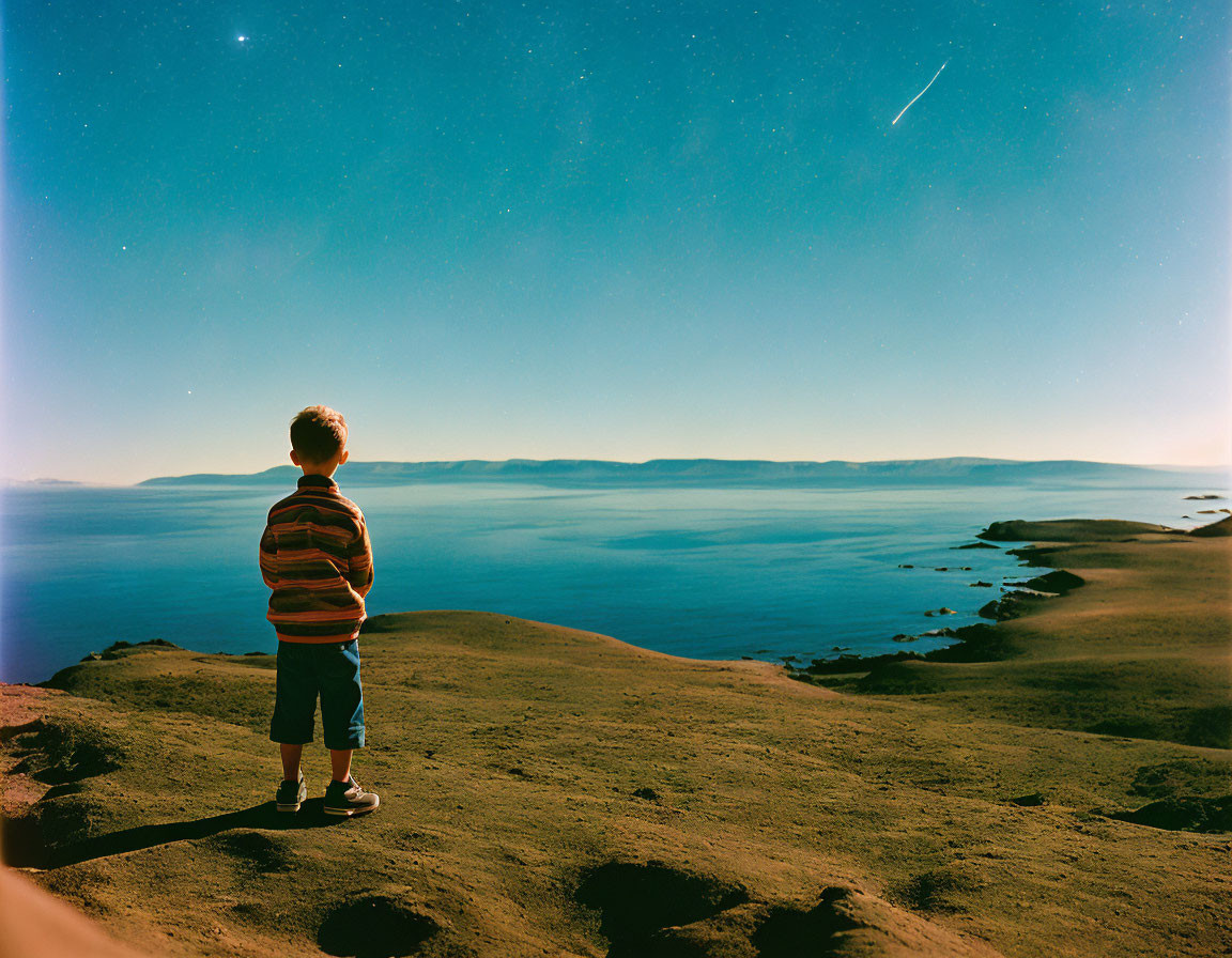 Child on Hill Gazes at Starlit Lake with Shooting Star