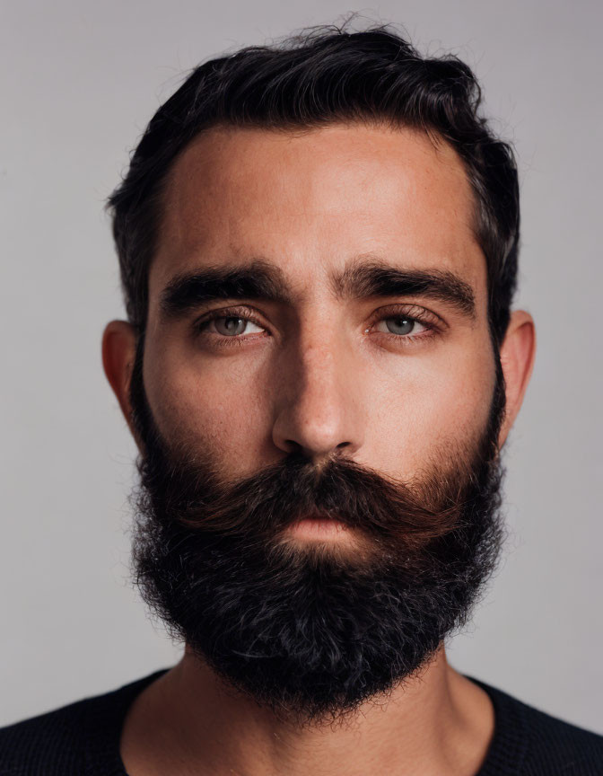 Intense Gaze Full Beard Man Portrait on Neutral Background