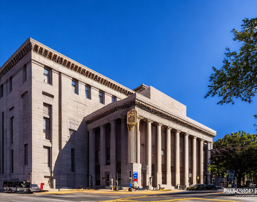 Stone building with columns, friezes, pediment, city streets, and trees