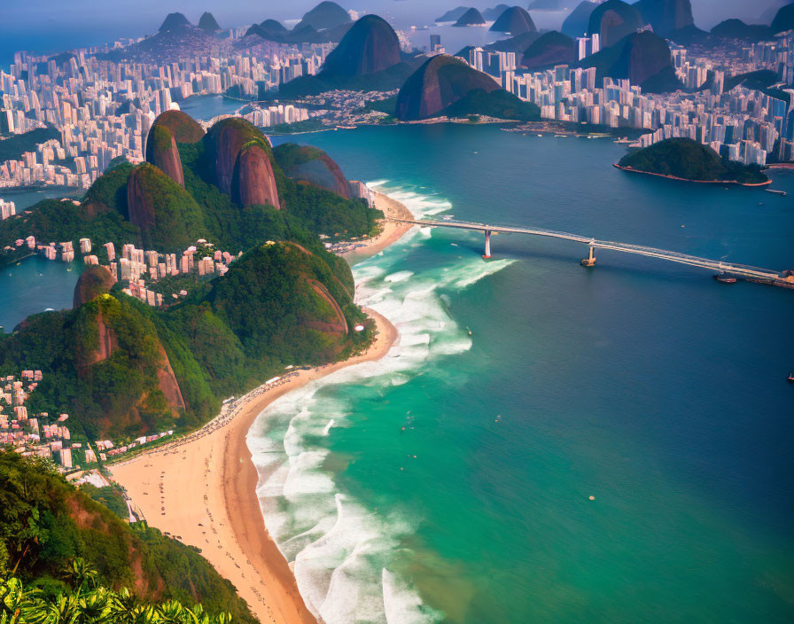 Coastal city with sandy beaches, mountain backdrop, bridges, urban high-rises, hazy