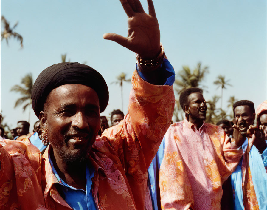 Vibrant Orange and Blue-Clad Men Under Clear Sky