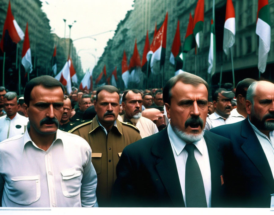 Military men in uniform marching in solemn parade with rows of flags