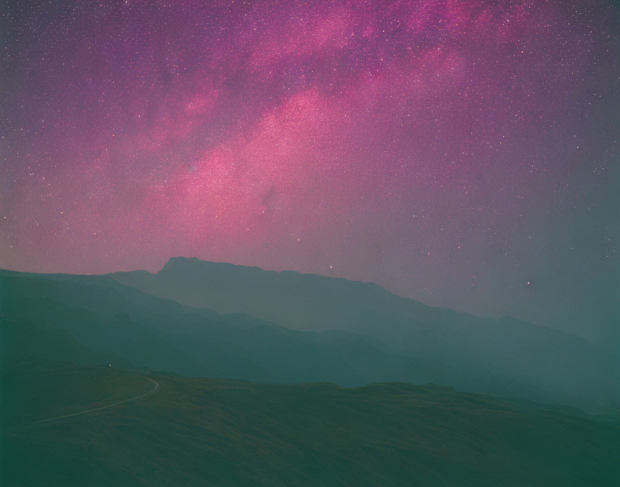Purple and Pink Night Sky Over Mountainous Terrain