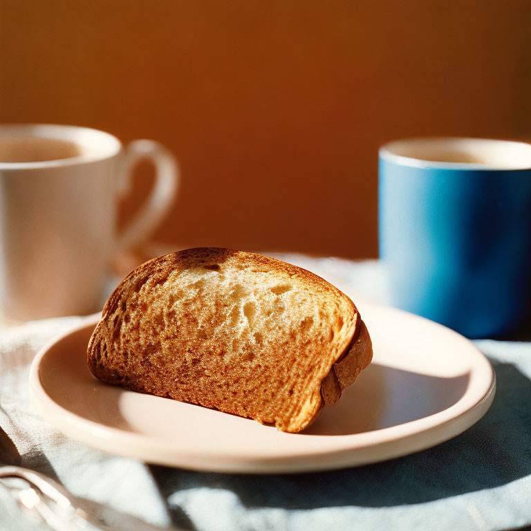 Toasted Bread Slice and Two Coffee Cups on Plate in Soft Lighting