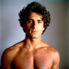 Intense shirtless man portrait with tousled hair and subtle shadow