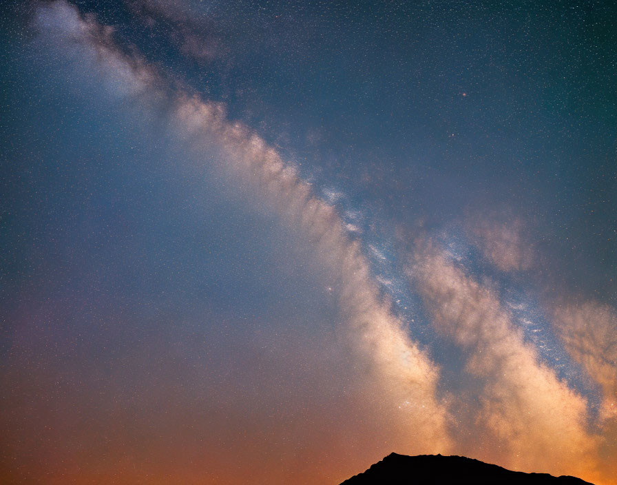 Starry Night Sky Over Silhouetted Mountain