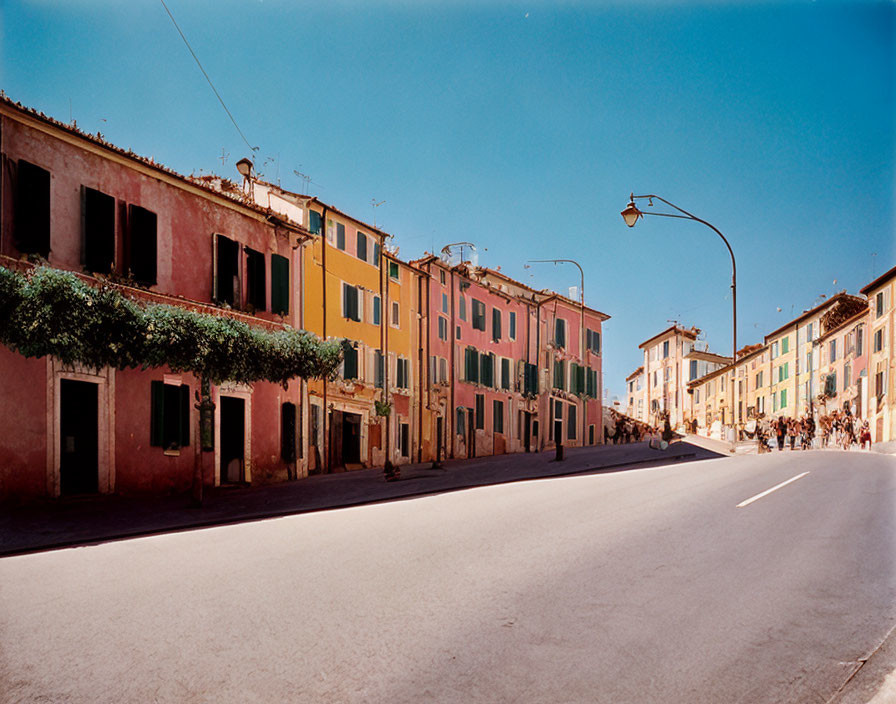 Colorful Two-Story Buildings on Wide Street with Street Lamps