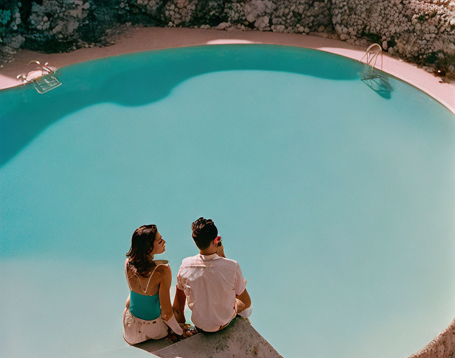 Poolside Scene: Couple Relaxing by Kidney-Shaped Pool