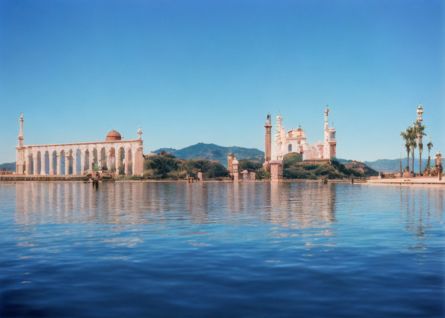 Architectural complex with domes and minarets by tranquil water