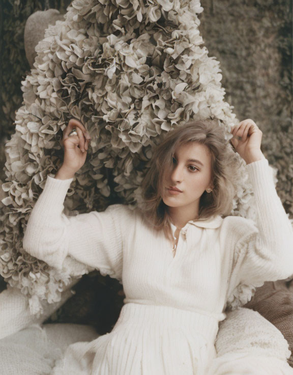 Woman in White Sweater Among Large Hydrangea Flowers