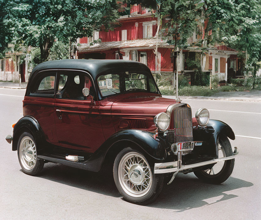 Vintage Maroon Car with White-Wall Tires and Round Headlights