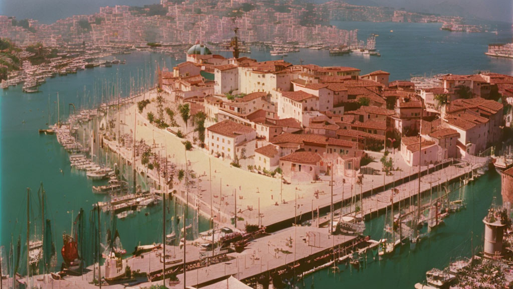 Coastal town panorama: terracotta-roofed buildings, boats on pier, calm blue