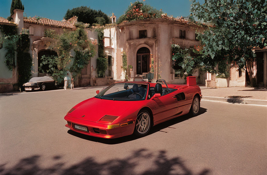 Red Classic Convertible Sports Car Parked on Cobblestone Street