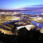 Historic European cityscape at twilight with illuminated buildings by the river