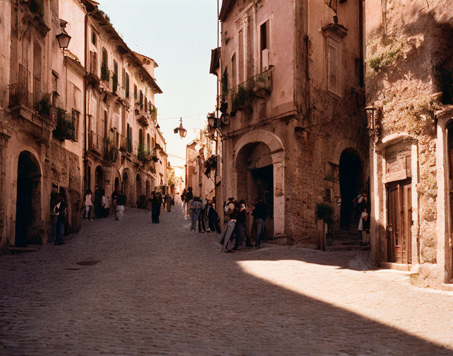 Traditional European village with cobblestone street and quaint buildings.