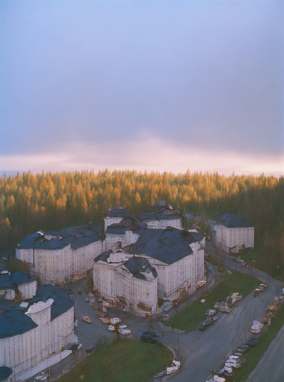 Tranquil sunset over forest-surrounded apartment complex