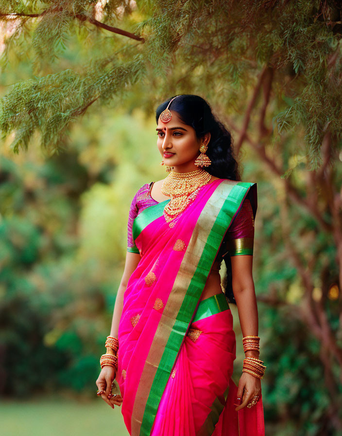 Woman in Vibrant Pink and Green Saree with Gold Jewelry Embracing Indian Ethnic Eleg