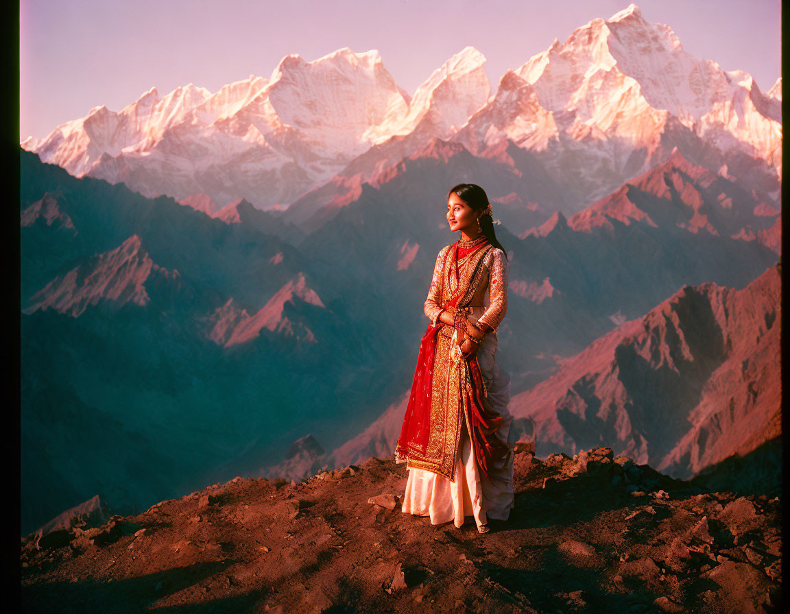 Traditional red outfit woman against sunset mountain range