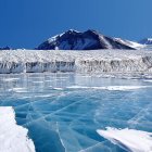 Glittering blue ice formations in surreal snowy landscape