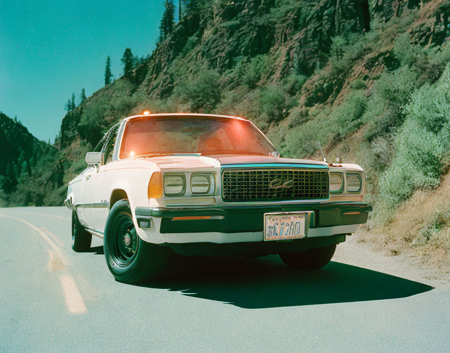 Vintage White Police Car with Red Roof Light on Sunlit Road