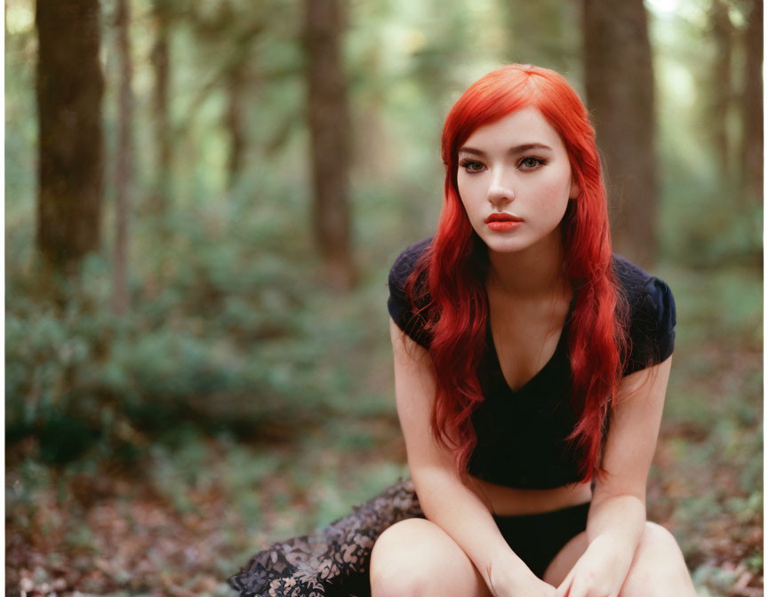 Vivid red-haired woman in lush forest gazes at camera