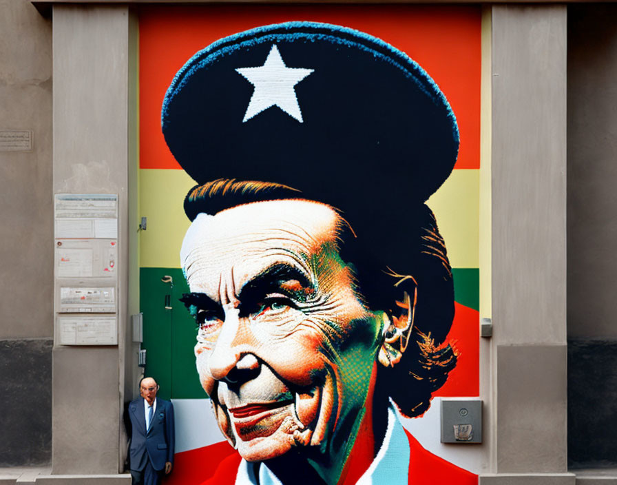 Colorful mural featuring person in military-style cap with star, real person in front.