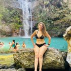 Woman in Black Bikini with Golden Arm Cuffs by Steaming Sea Geyser