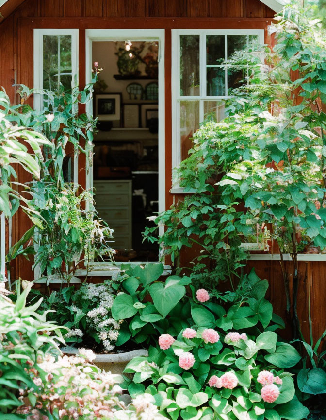 House window surrounded by greenery and flowers, peeking into a cozy interior