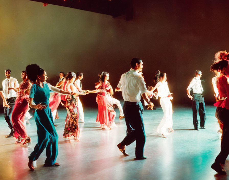 Colorfully Attired Group Dancing in Spotlight-lit Hall