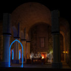 Medieval room with stone arches, neon blue light, and candles