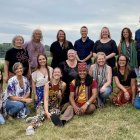 Traditional Slavic attire group photo in flower-filled meadow