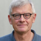 Smiling man portrait with glasses and white hair