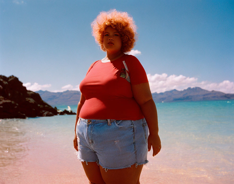 Person with Curly Hair in Red T-shirt on Sunny Beach