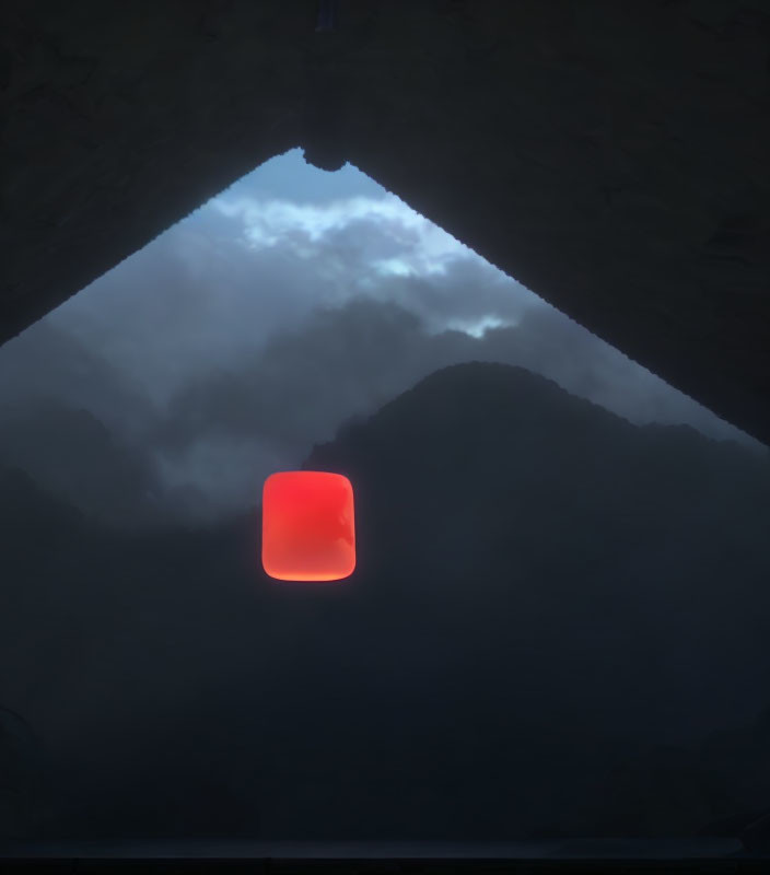 Red lantern hanging in entrance of dark cave with mountain backdrop