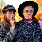 Fashionable women in bold makeup and hats, one holding a cup and the other vaping, wearing trendy