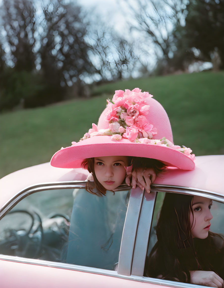 Person in Pink Flowered Hat Looking Out Classic Car Window