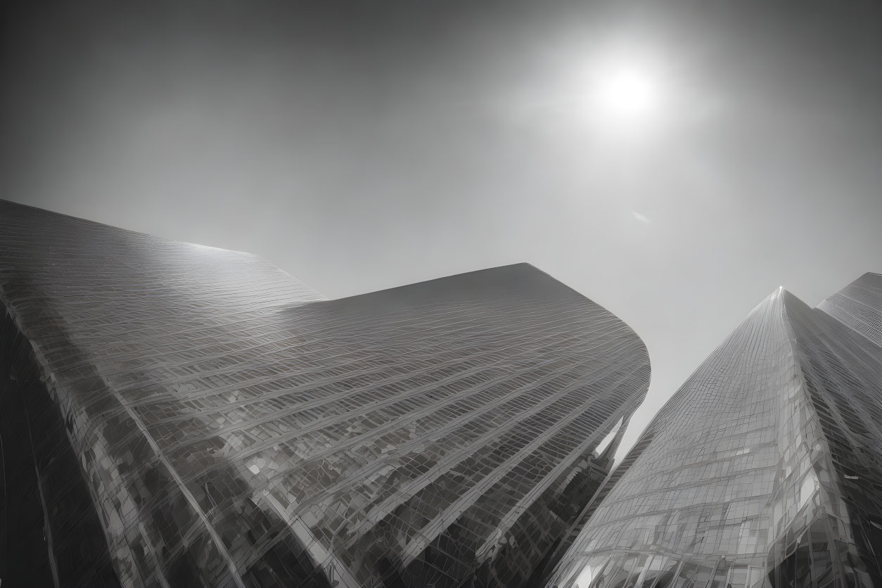 Cityscape skyscrapers in monochrome with sun and reflections.