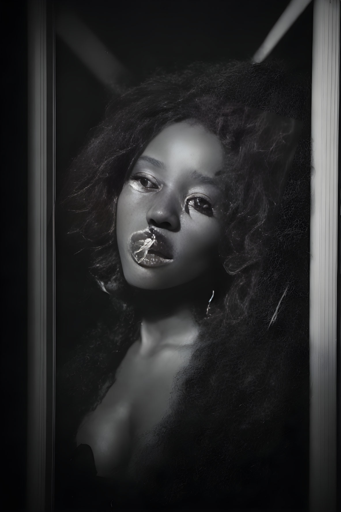 Dramatic monochrome portrait of woman with curly hair and bold makeup