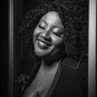 Dramatic monochrome portrait of woman with curly hair and bold makeup