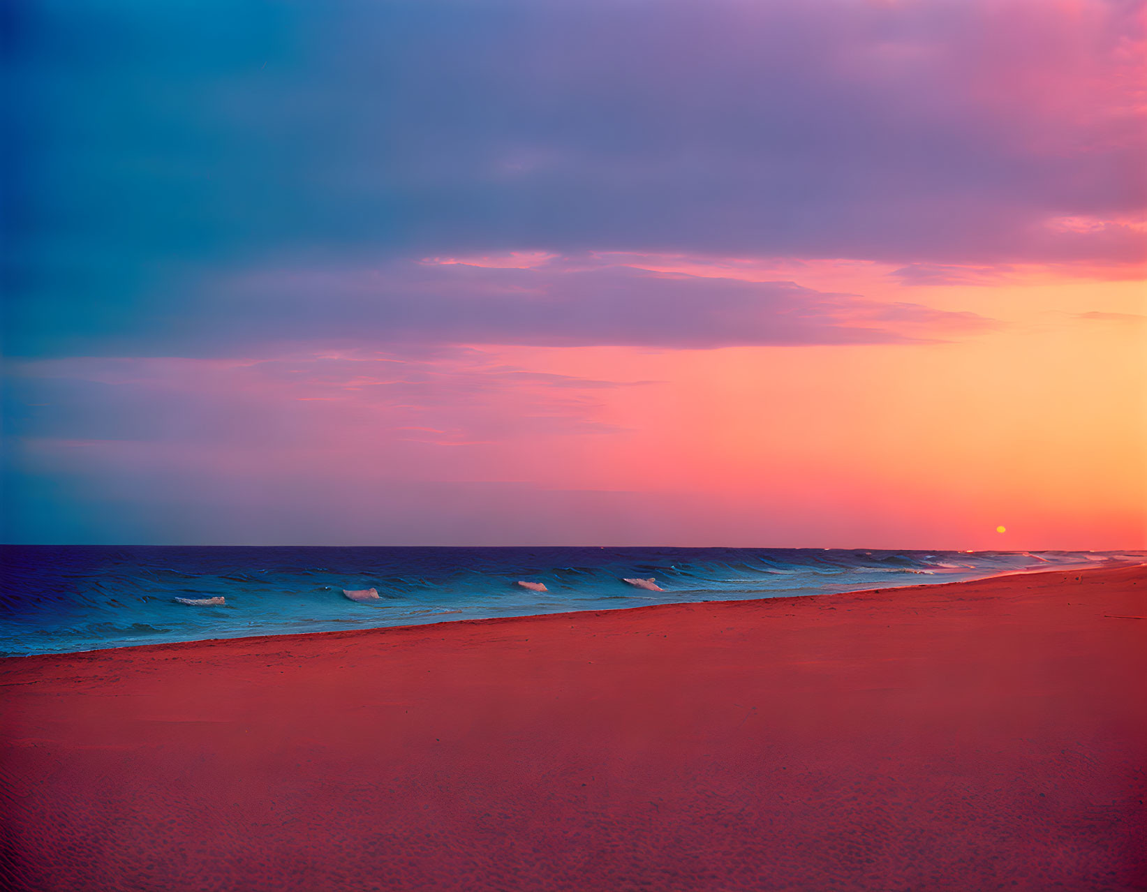 Vibrant Pink and Blue Sunset Over Serene Beach