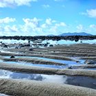 Futuristic floating structures in rocky landscape under cloudy sky